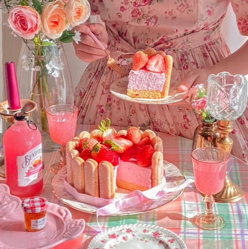 someone holding a slice of strawberry cake