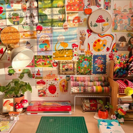 someone's desk filled with drawings and art supplies